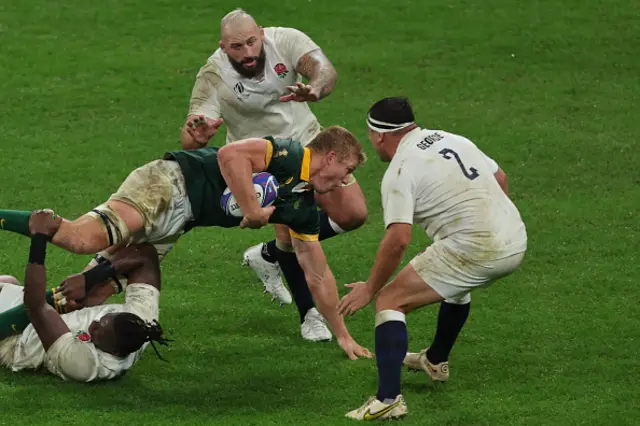 South Africa's openside flanker Pieter-Steph du Toit is tackled by England's lock Maro Itoje