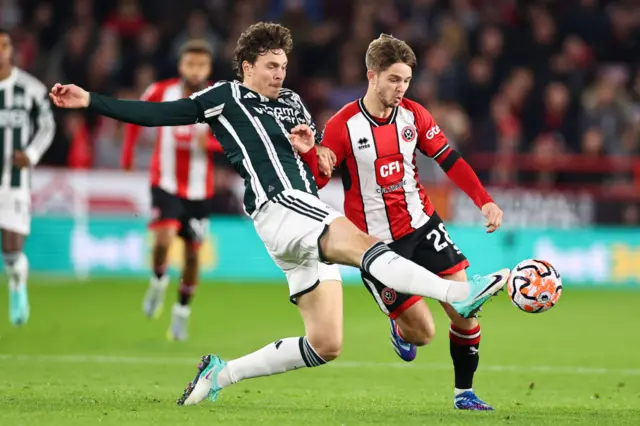 Lindelof challenges McAtee for the ball.