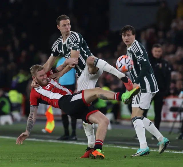 McBurnie is challenged by Evans from behind.