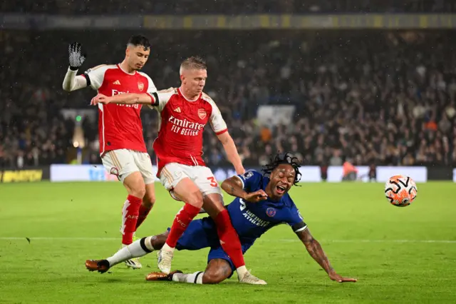 Oleksandr Zinchenko of Arsenal clashes with Raheem Sterling