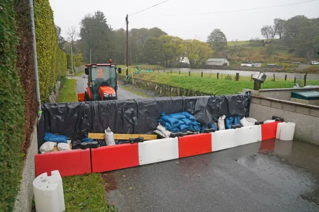 A resident flood barrier in Kintore as Storm Babet batters the country and a rare red weather warning is in place for parts of eastern Scotland all day on Saturday.