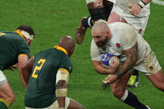 England's loosehead prop Joe Marler runs with the ball