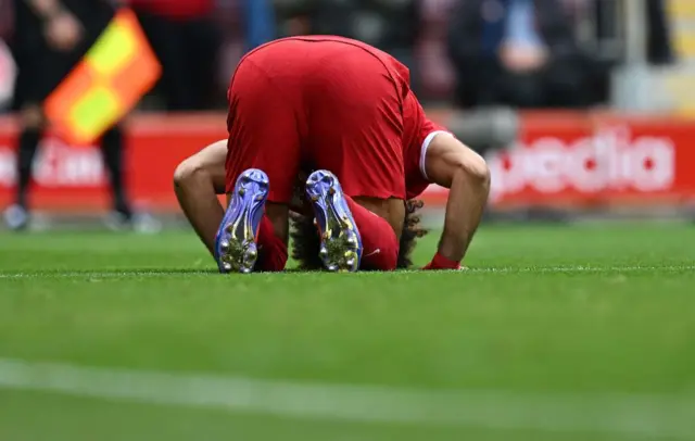 Mohamed Salah kisses the pitch