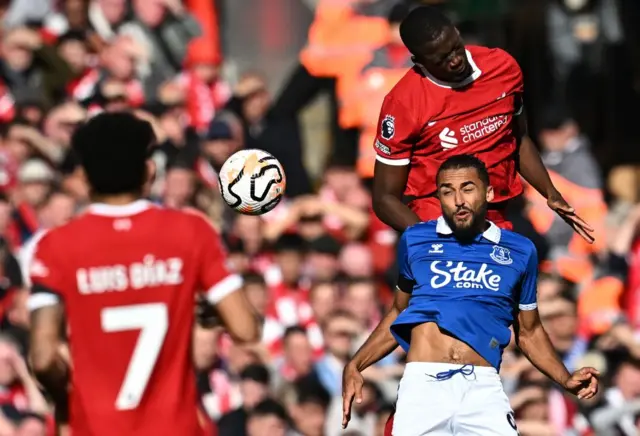 Liverpool's French defender Ibrahima Konate jumps above Everton's English striker Dominic Calvert-Lewin