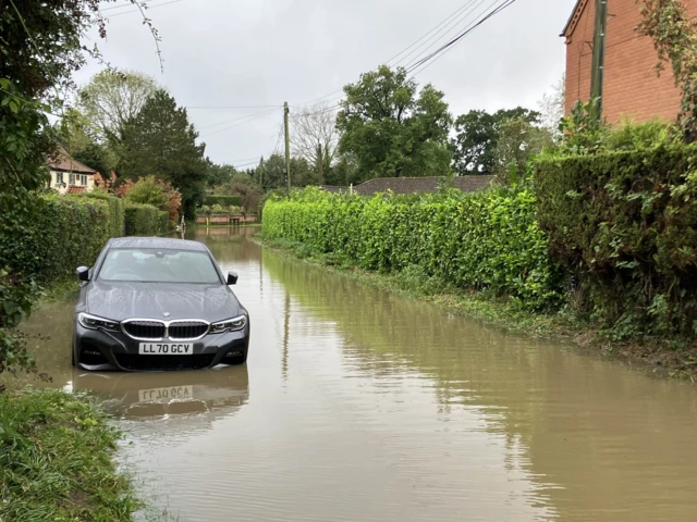 A car stuck in flood water in Wraplingham in Norfolk