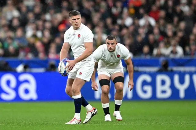 Owen Farrell of England kicks off