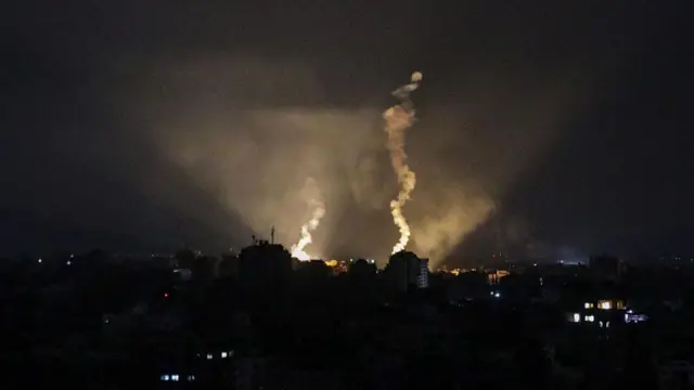 Israeli army flares illuminate the sky over Gaza City, 22 October 2023