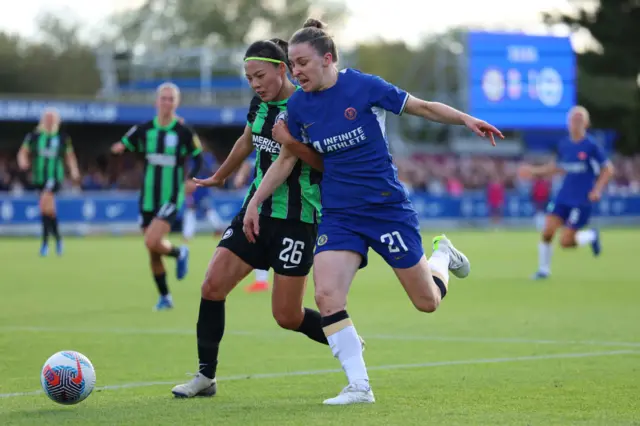 Li Mengwen of Brighton & Hove Albion battles for possession with Niamh Charles