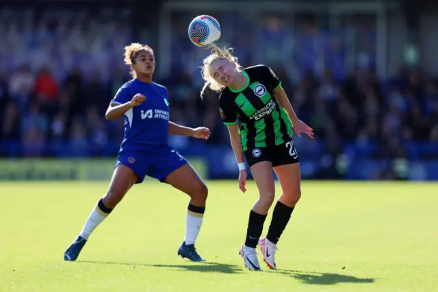 Katie Robinson of Brighton & Hove Albion battles for possession with Jess Carter