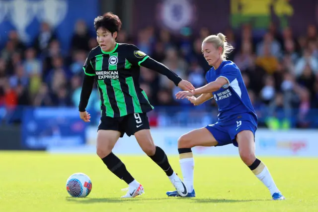 Lee Geum-Min of Brighton & Hove Albion battles for possession with Sophie Ingle