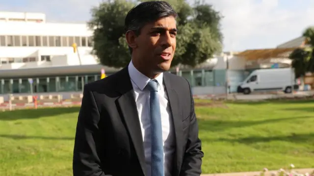 Rishi Sunak speaks outside