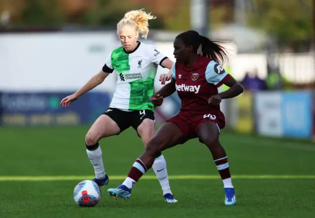 Grace Fisk of Liverpool is challenged by Viviane Asseyi