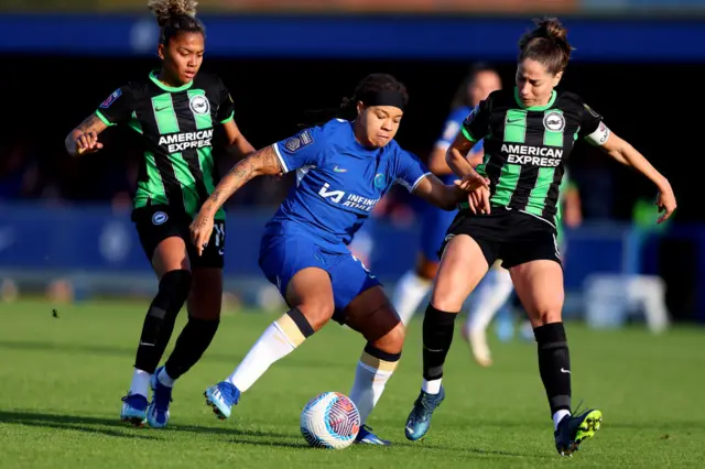 Mia Fishel of Chelsea battles for possession with Jorelyn Carabali and Vicky Losada