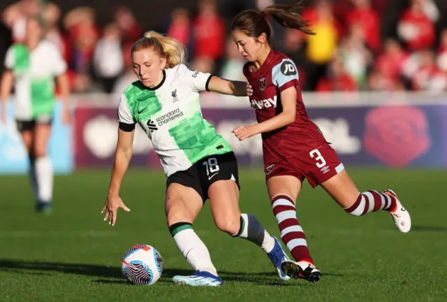 Ceri Holland of Liverpool is challenged by Risa Shimizu