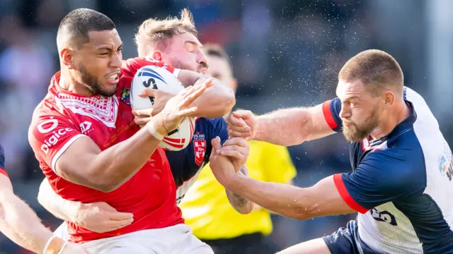 England and Tonga battle for the ball