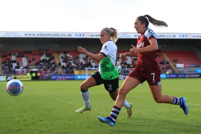 Emma Koivisto of Liverpool is challenged by Lisa Evans