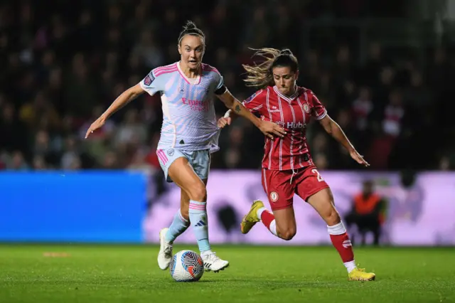 Caitlin Foord of Arsenal battles for possession with Ffion Morgan