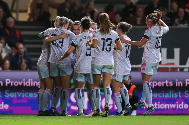 Katie McCabe of Arsenal celebrates with team mates after scoring the team's second goal