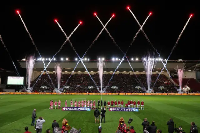 General view inside the stadium as fireworks are seen whilst players of both side's line up