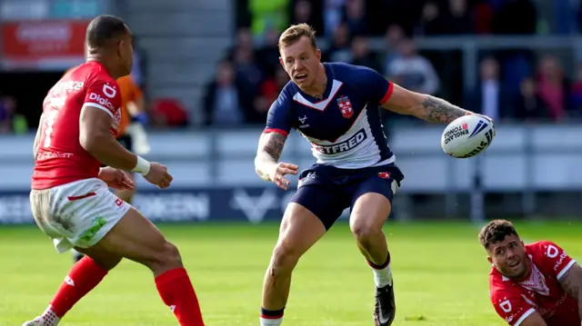 Tom Johnstone runs at Tonga defence