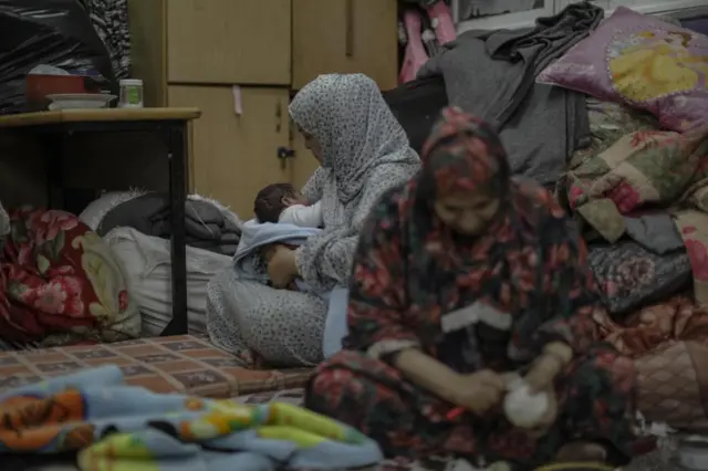 Internally displaced Palestinians spend the night at a United Nations school in Khan Younis, southern Gaza, 22 October 2023