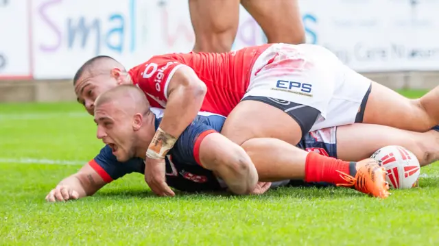 Mikey Lewis scores a try for England