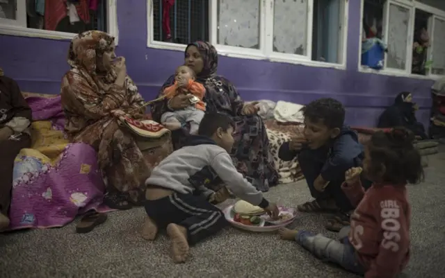 Internally displaced Palestinians spend the night at a United Nations school in Khan Younis, southern Gaza, 22 October 2023.