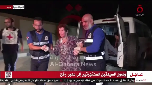 A still of a video from Al-Qahera News showing one of the freed hostages being escorted by medical personnel