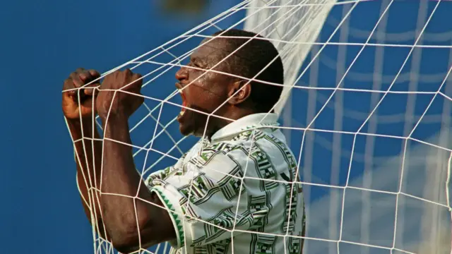 Nigerian Rashidi Yekini screams 21 June 1994 through the net after scoring the first goal at the Cotton Bowl in Dallas during their World Cup match against Bulgaria. Amokachi himself later scored the second goal for his team