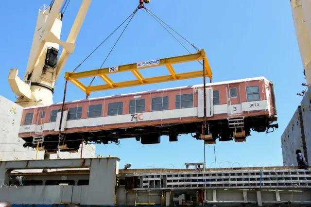 A carriage for the Tanzania's Standard Gauge Railway (SGR) project is unloaded as Tanzania received 14 economy class carriages of South Korean company Sung Shin Rolling Stock (SSRT) at the port in Dar es Salaam on November 25, 2022.