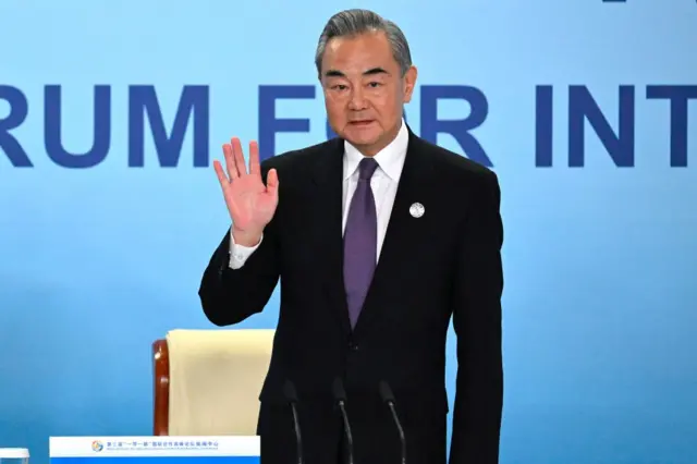 Chinese Foreign Minister Wang Yi waves at a press briefing during the Third Belt and Road Forum for International Cooperation in Beijing on October 18, 2023