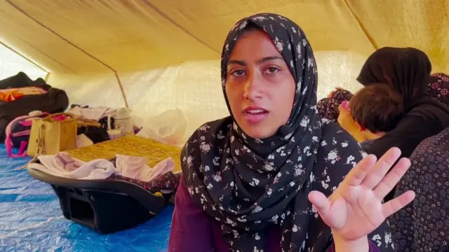 Sojood Najim speaking to the camera in a tent