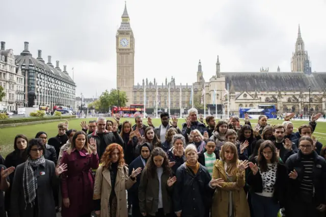 People attend a vigil to mourn the children killed in Gaza with attendees displaying the names of dead children on their palms at the event organized by non-profit organization 'Medical Aid for Palestinians' at Parliament Square in London, Britain, 24 October 2023