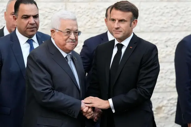 Emmanuel Macron and Mahmoud Abbas shaking hands in Ramallah