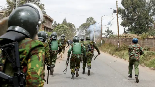 Police officers run as they confront with demonstrators during an anti-government protest against the imposition of tax hikes by the government in Nairobi, Kenya July 19, 2023