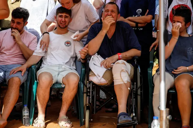 A man crying at a funeral