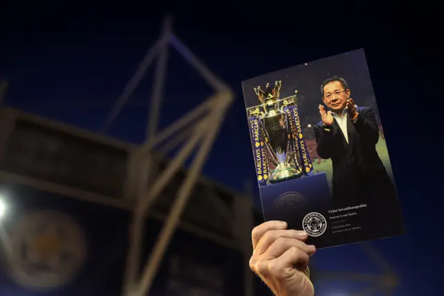 Leicester City matchday programme being held up outside the King Power stadium