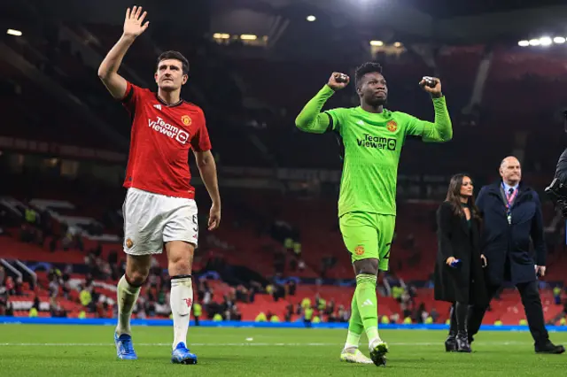 Harry Maguire of Manchester United and goalkeeper Andre Onana walk off together