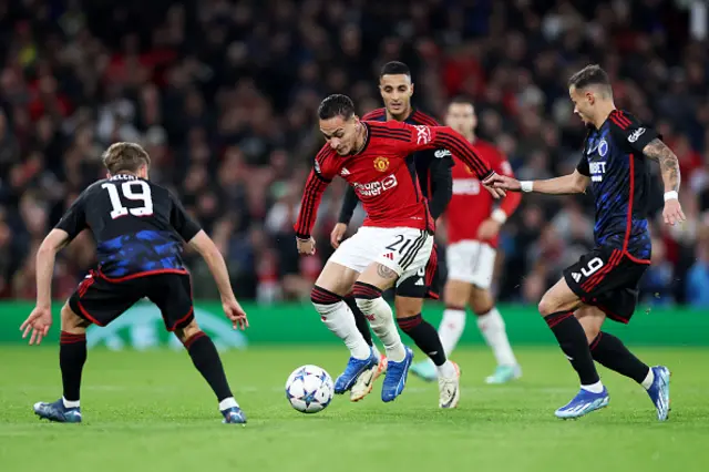 Antony of Manchester United is challenged by Elias Jelert