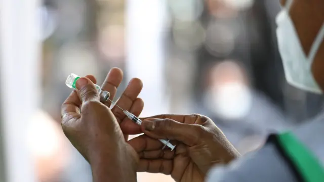 A Nigerian health worker administering a vaccination