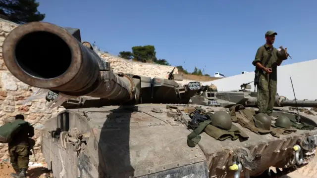 Israeli soldiers and armored vehicles along the Israel-Lebanon border