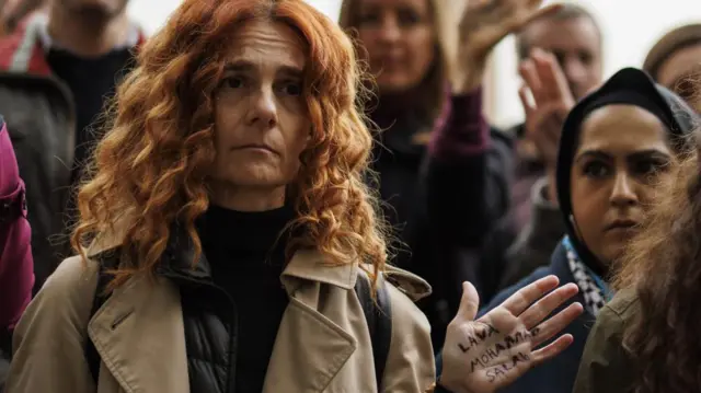 People attend a vigil to mourn the children killed in Gaza with attendees displaying the names of dead children on their palms at the event organized by non-profit organization 'Medical Aid for Palestinians' at Parliament Square in London, Britain, 24 October 2023