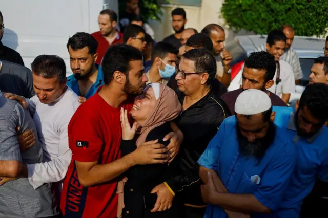 Mourners react as they attend a funeral of Palestinians killed in Israeli strikes in Khan Younis