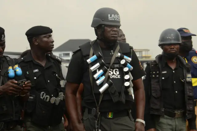 Police officers look on during a protest to commemorate one year anniversary of #EndSars, a protest against a military attack on protesters at Lekki tollgate in Lagos, Nigeria, on October 20, 2021.