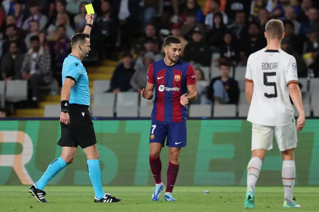 Slovak referee Ivan Kruzliak presents a yellow card