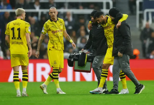 Emre Can helped off the pitch