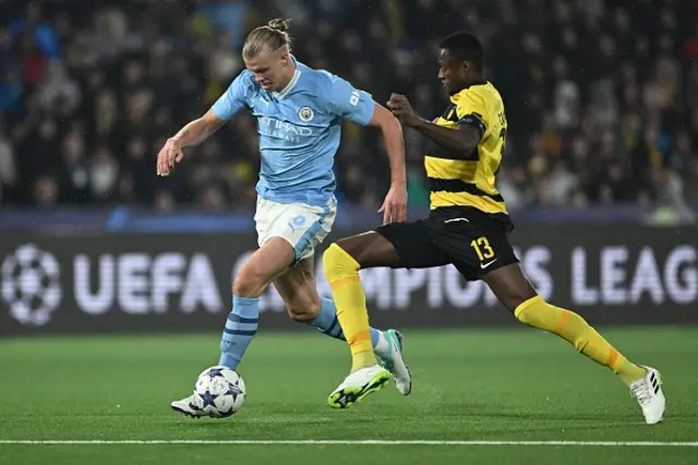 Erling Haaland is challenged by a Young Boys player