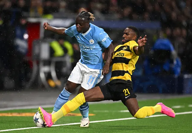 Jeremy Doku of Manchester City is challenged by Ulisses Garcia