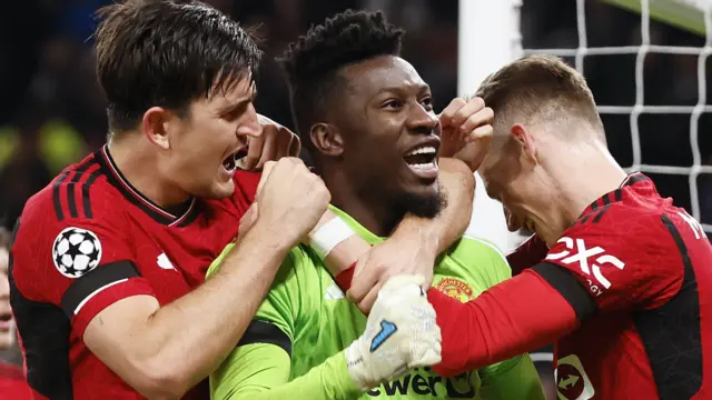 Harry Maguire and Scott McTominay celebrate with Andre Onana