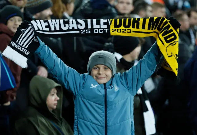 Newcastle supporter holding a scarf